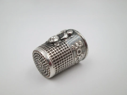 Sewing thimble. Sterling silver. Bear relief figure and vegetable motifs. Europe. 1960's