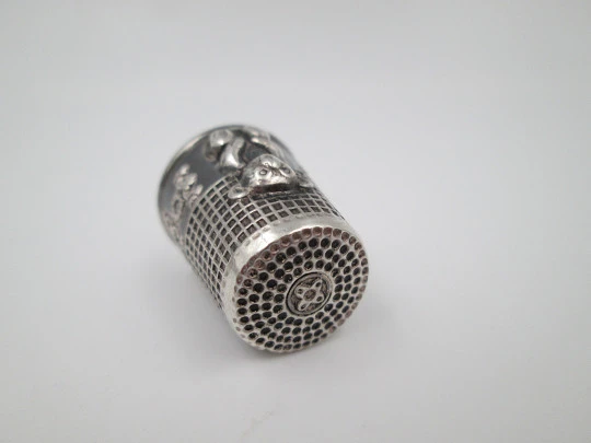 Sewing thimble. Sterling silver. Bear relief figure and vegetable motifs. Europe. 1960's
