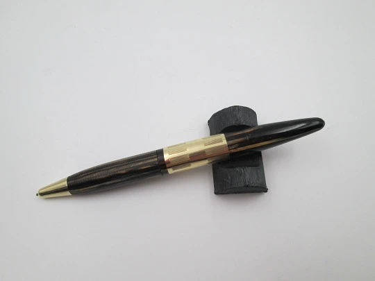 Sheaffer Tuckaway. Celuloide estriado marmolizado y chapados oro. Giratorio. 1940