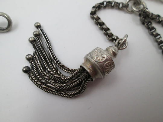 Silver pocket watch chain. Ball and acorns motifs. T-bar. Lobster clasp. Europe. 1910's