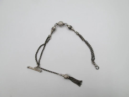 Silver pocket watch chain. Ball and acorns motifs. T-bar. Lobster clasp. Europe. 1910's