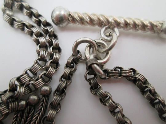 Silver pocket watch chain. Ball and acorns motifs. T-bar. Lobster clasp. Europe. 1910's