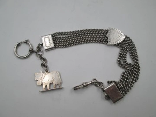 Sterling silver chatelaine. Four chains. Sliding shield. Cow charm. 1910's