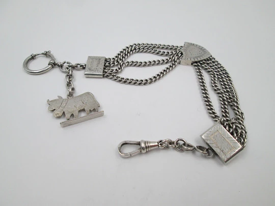 Sterling silver chatelaine. Four chains. Sliding shield. Cow charm. 1910's