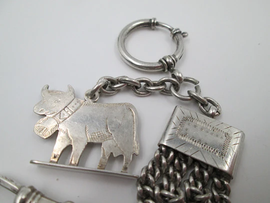 Sterling silver chatelaine. Four chains. Sliding shield. Cow charm. 1910's