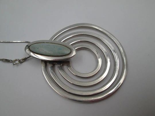 Sterling silver women's necklace. Concentric circles pendant with cord. Blue stone. 1980's