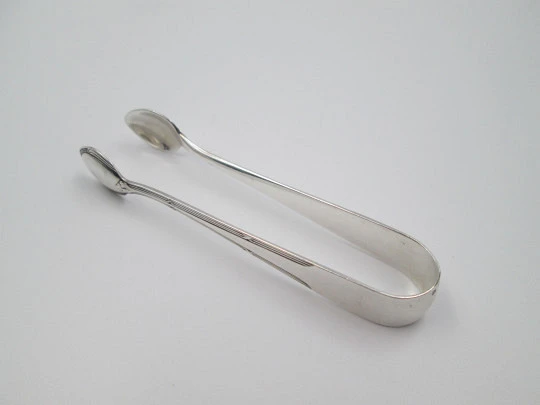 Sugar tongs. Silver plated metal. Ribbed design and flowers. Europe. 1950's