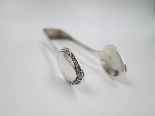 Sugar tongs. Silver plated metal. Ribbed design and flowers. Europe. 1950's