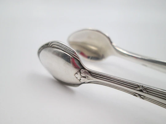 Sugar tongs. Silver plated metal. Ribbed design and flowers. Europe. 1950's