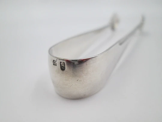 Sugar tongs. Silver plated metal. Ribbed design and flowers. Europe. 1950's