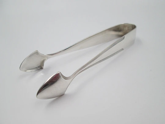 Sugar tongs. Silver plated metal. Ribbed design and triangular head. Europe. 1950's