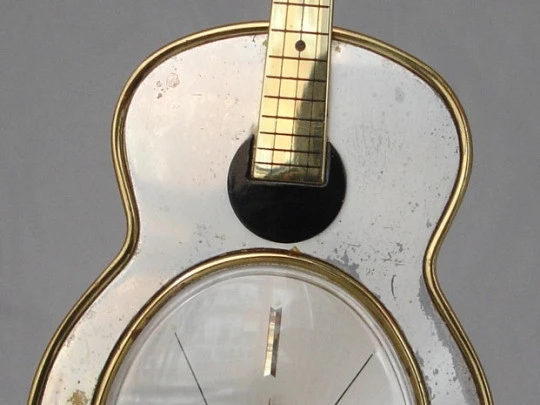 Swiza musical clock. Hand winding. Bronze. Sheffield guitar shape. 1970's