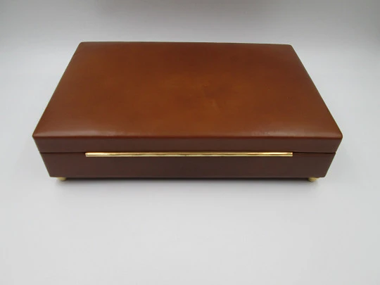 Tabaquera musical de despacho y escritorio. Madera y piel marrón. Cuerda manual. 1970