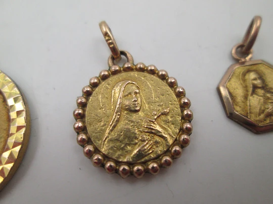 Three religious medals. Gold plated metal. Virgin Mary. Handle and ring. Spain. 1970's