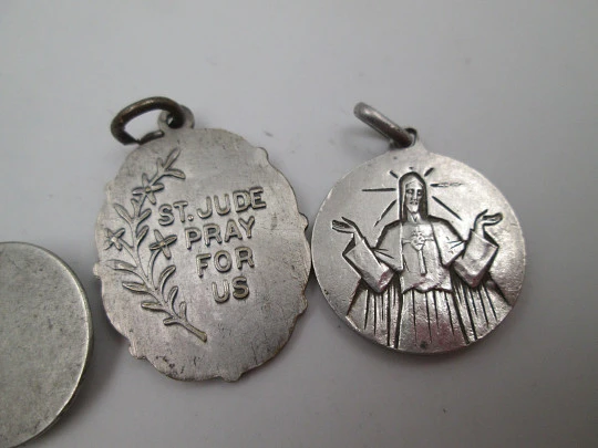 Three religious medals. Sterling silver & silver plated. Christ, Virgin of Carmen and Saint Jude Three religious medals. Sterling silver & silver plated. Christ, Virgin of Carmen and Saint Jude