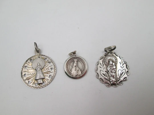 Three religious medals. Sterling silver. Virgin of the Pillar and Lady of the Rosary. 1970's