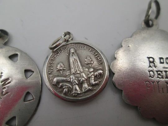 Three religious medals. Sterling silver. Virgin of the Pillar and Lady of the Rosary. 1970's Three religious medals. Sterling silver. Virgin of the Pillar and Lady of the Rosary. 1970's