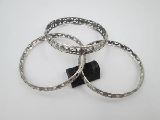 Three women's openwork bangles. Sterling silver. Geometric & floral motifs