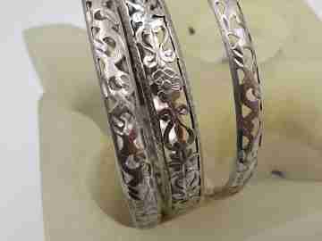Three women's openwork bangles. Sterling silver. Geometric & floral motifs
