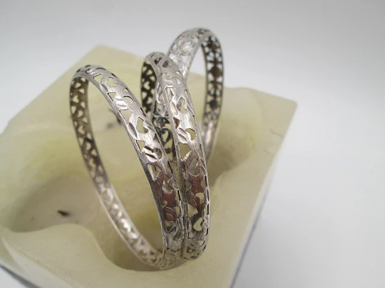 Three women's openwork bangles. Sterling silver. Geometric & floral motifs