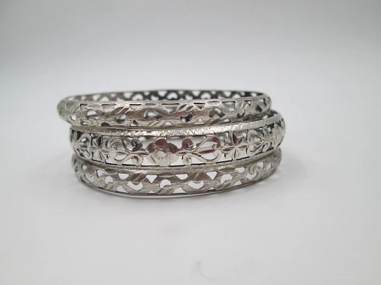 Three women's openwork bangles. Sterling silver. Geometric & floral motifs