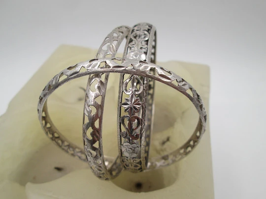 Three women's openwork bangles. Sterling silver. Geometric & floral motifs