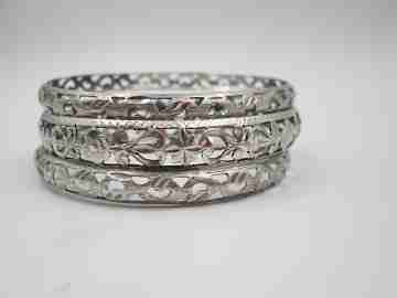 Three women's openwork bangles. Sterling silver. Geometric & floral motifs