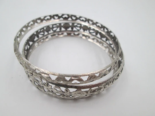 Three women's openwork bangles. Sterling silver. Geometric & floral motifs