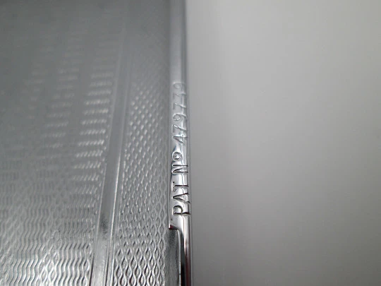 Tiki cigarette case with petrol lighter. Silver plated metal. Waves motifs. England. 1960's