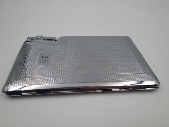 Tiki cigarette case with petrol lighter. Silver plated metal. Waves motifs. England. 1960's