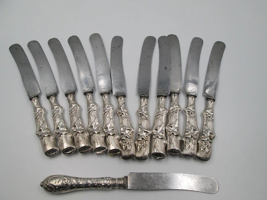 Twelve dessert knives boxed. Silver handles. Vegetable motifs. 1950's