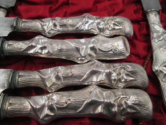 Twelve dessert knives boxed. Silver handles. Vegetable motifs. 1950's