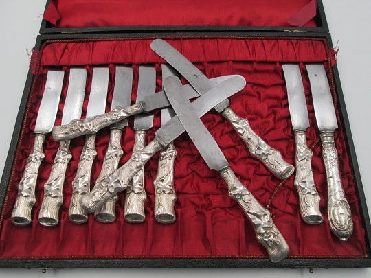 Twelve dessert knives boxed. Silver handles. Vegetable motifs. 1950's