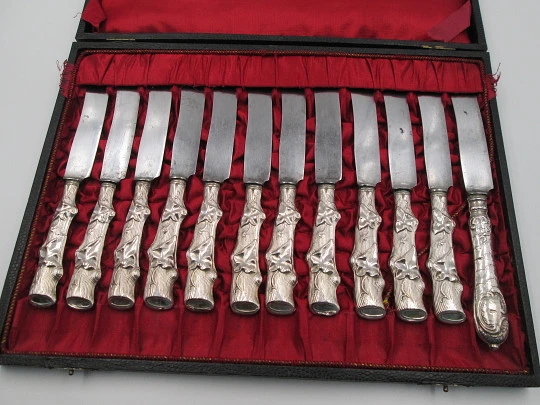 Twelve dessert knives boxed. Silver handles. Vegetable motifs. 1950's