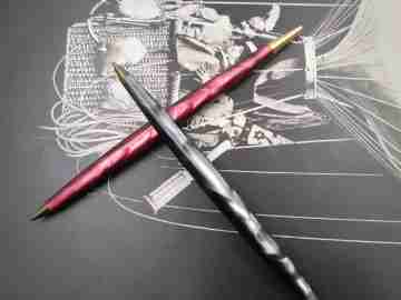 Two ballpoint pens. Red and grey pearl marble resin. Gold plated details. 1950's