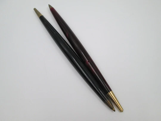 Two ballpoint pens. Red and grey pearl marble resin. Gold plated details. 1950's