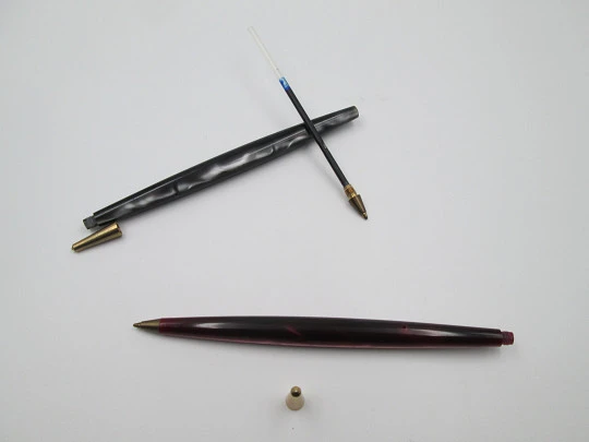 Two ballpoint pens. Red and grey pearl marble resin. Gold plated details. 1950's