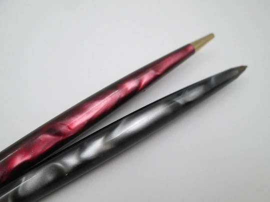 Two ballpoint pens. Red and grey pearl marble resin. Gold plated details. 1950's