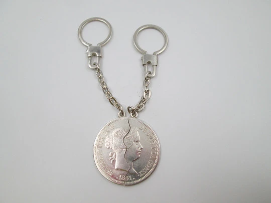 Two keychains. 900 sterling silver. Queen Isabel II. Divided 20 real coin