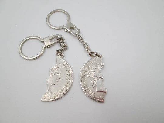 Two keychains. 900 sterling silver. Queen Isabel II. Divided 20 real coin