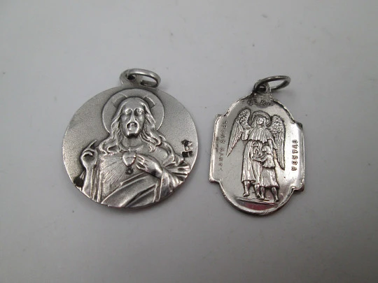 Two religious medals. Sterling silver. Virgin of Montserrat and Guardian Angel. 1960's