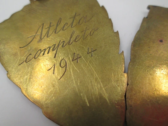 Two triangular sport medals. Gold plated metal and colours enamel. 1944. Spain