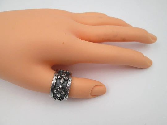 Unisex broad ring. Sterling silver. Fleur-de-lis relief ornaments. Europe. 1990's