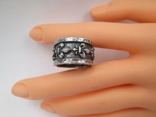 Unisex broad ring. Sterling silver. Fleur-de-lis relief ornaments. Europe. 1990's