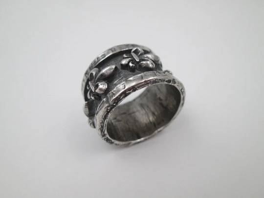 Unisex broad ring. Sterling silver. Fleur-de-lis relief ornaments. Europe. 1990's