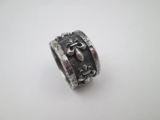 Unisex broad ring. Sterling silver. Fleur-de-lis relief ornaments. Europe. 1990's
