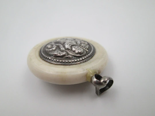 Unisex round pendant. Ivory paste & sterling silver. Warrion and saint relief. 1940's. Europe