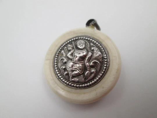 Unisex round pendant. Ivory paste & sterling silver. Warrion and saint relief. 1940's. Europe