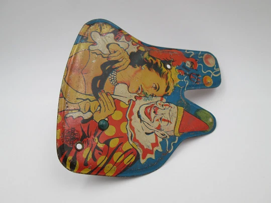 US Metal toy rattle. Lithographed tinplate and wood handle. Clown scene. 1940's. USA