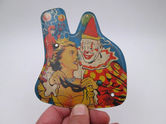 US Metal toy rattle. Lithographed tinplate and wood handle. Clown scene. 1940's. USA